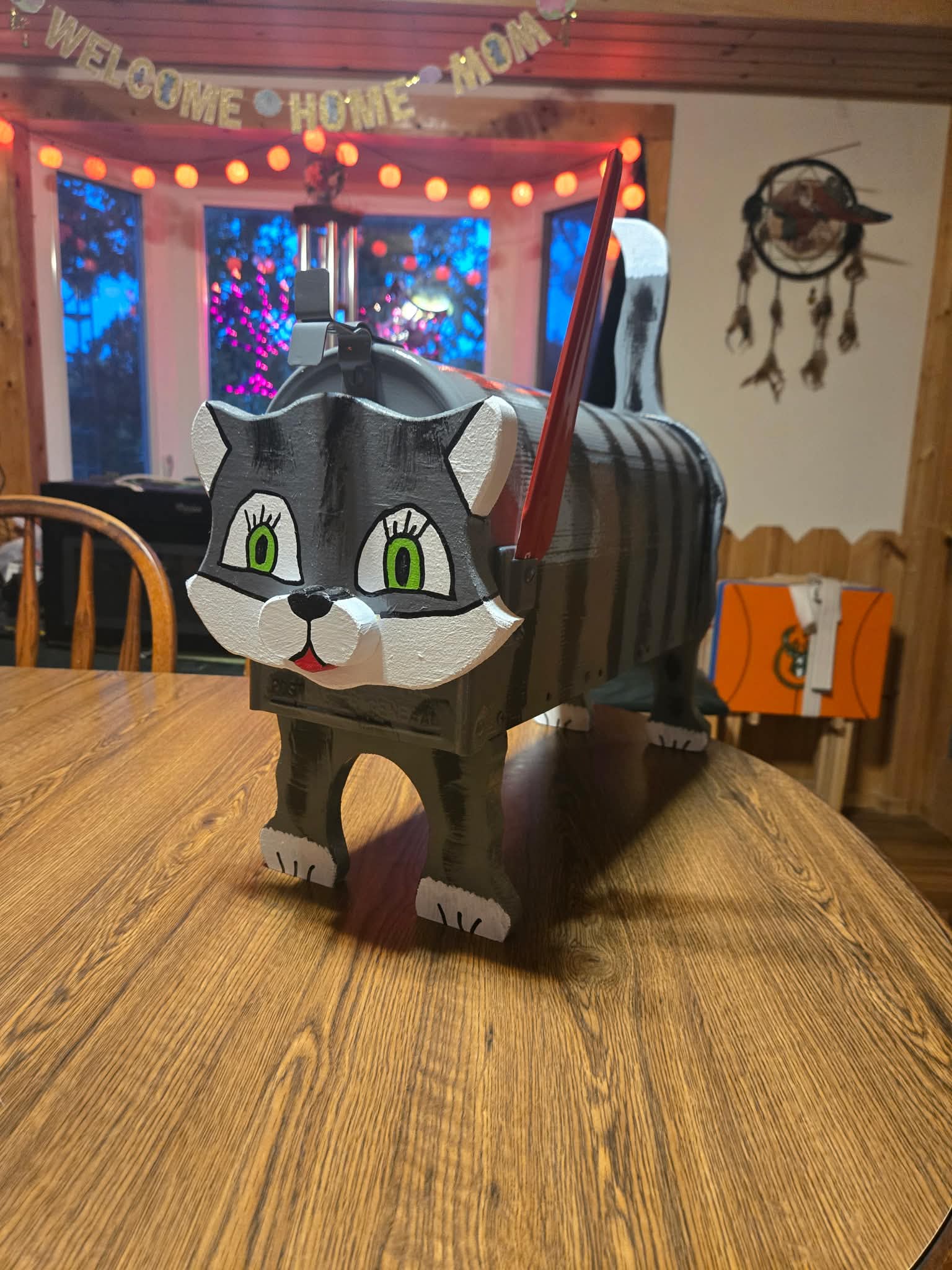 Custom wooden mailbox shaped and painted like a gray cat with green eyes
