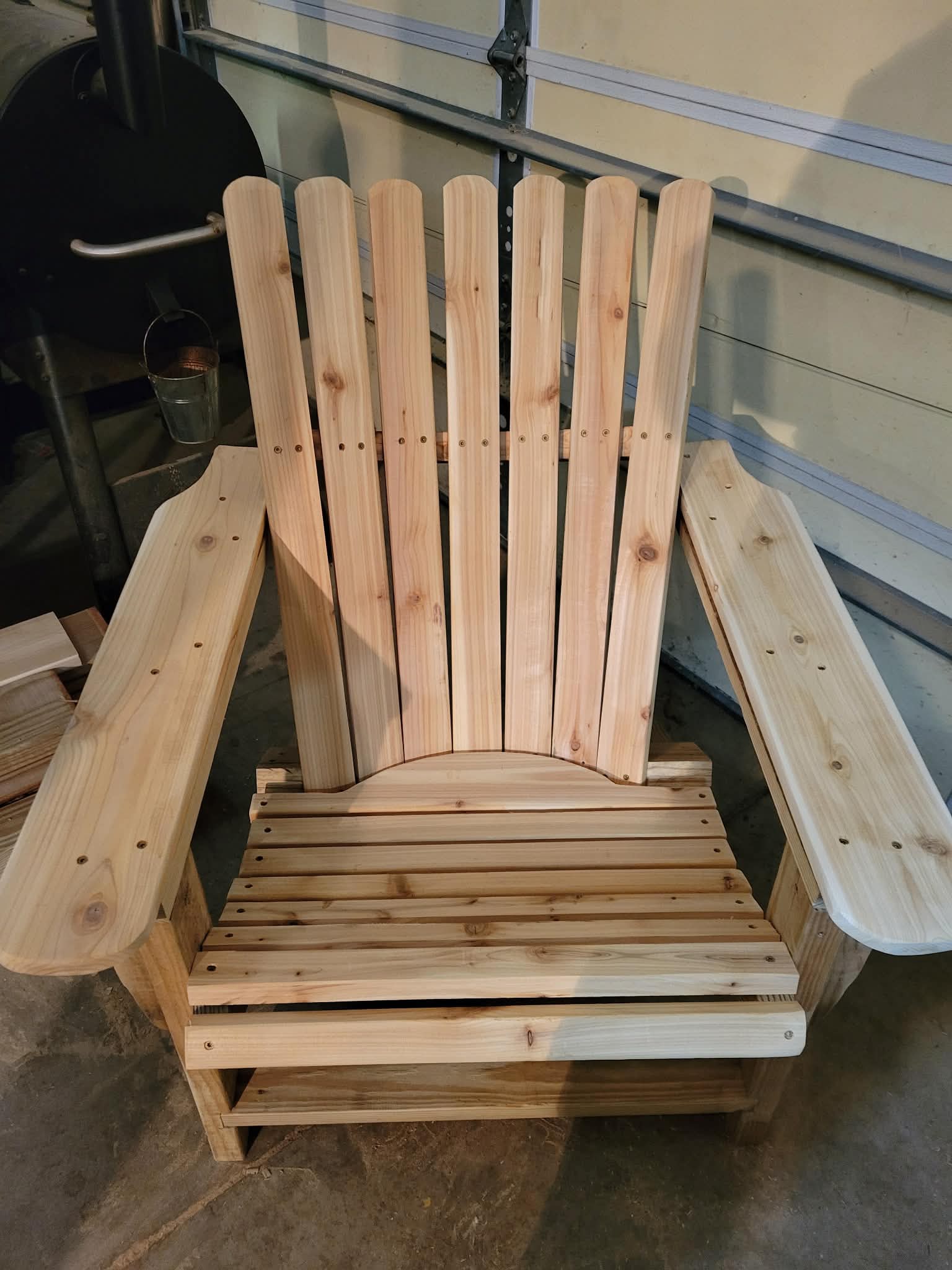 Handcrafted natural cedar Adirondack chair, front view showing fan back and wide armrests
