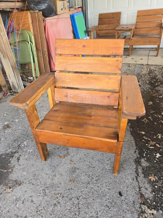 Handcrafted stained wooden lawn chair with slatted back and wide armrests