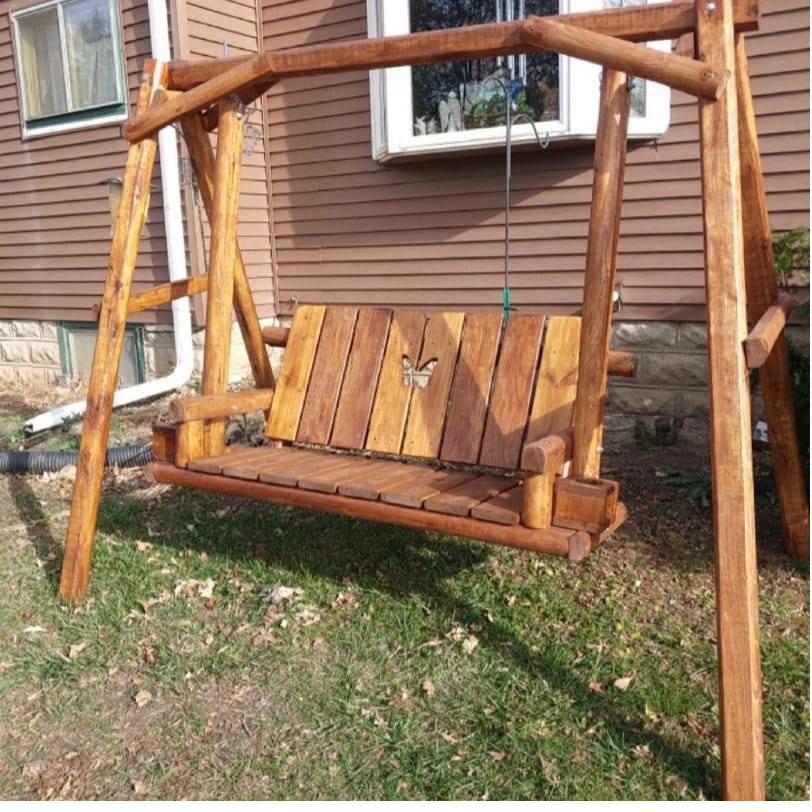 A-frame yard swing with carved butterfly on backrest