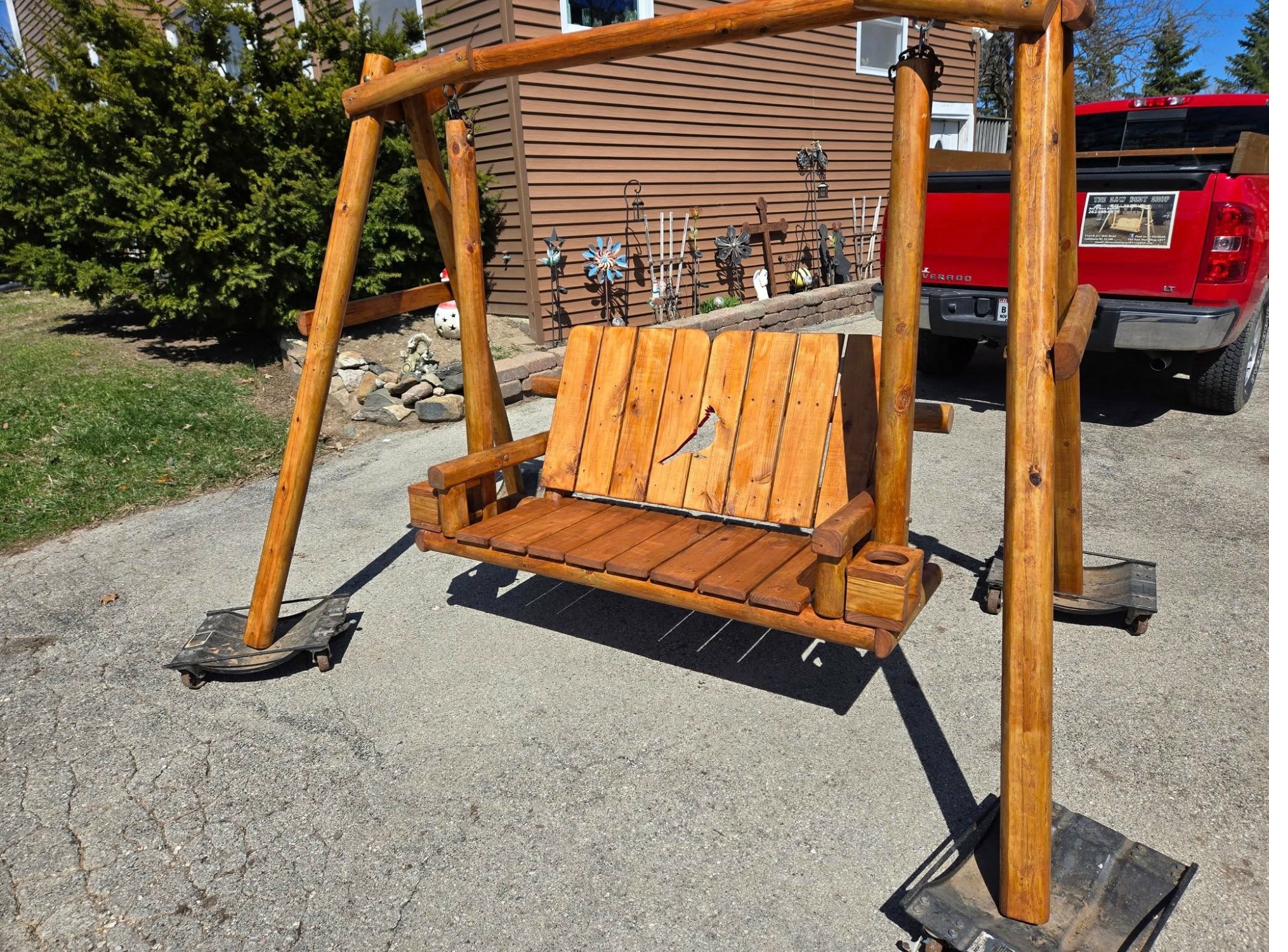 Handcrafted A-frame wooden yard swing with carved cardinal bird cutout